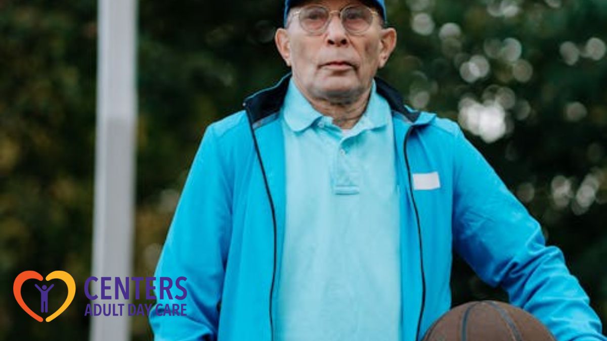 An older man holding a basketball, looking at the camera and appearing prepared for a day of activity.