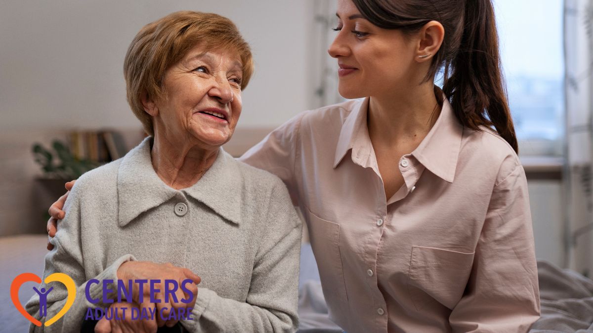 A caregiver shares a joyful bonding moment with an elderly woman in her care, illustrating adult day care services.