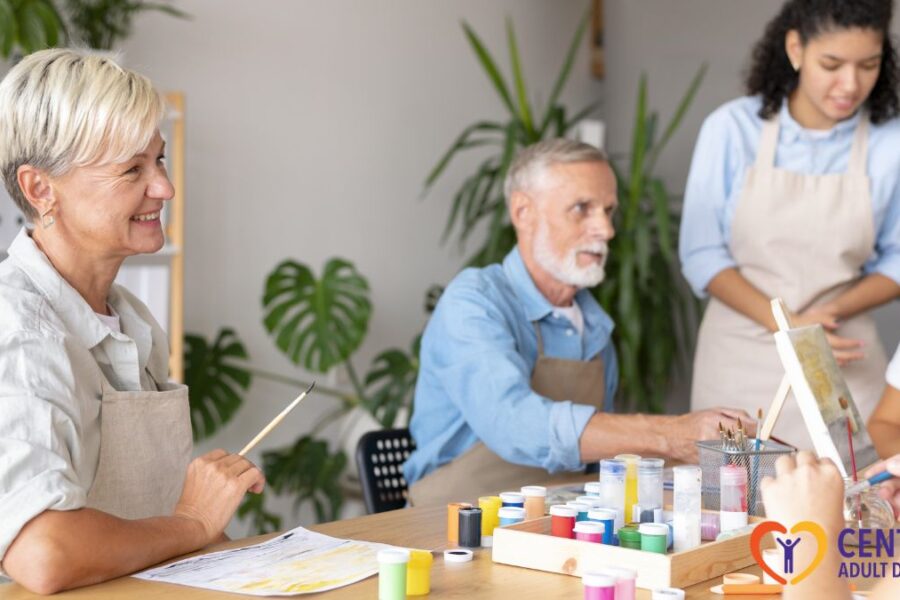 Group of seniors in Richmond enjoying an art activity in a bright, well-lit room with staff supervision.