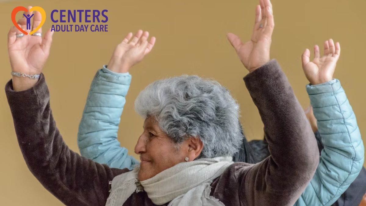 Adult day care services session where a group of seniors raise their hands and arms during a gentle group exercise.