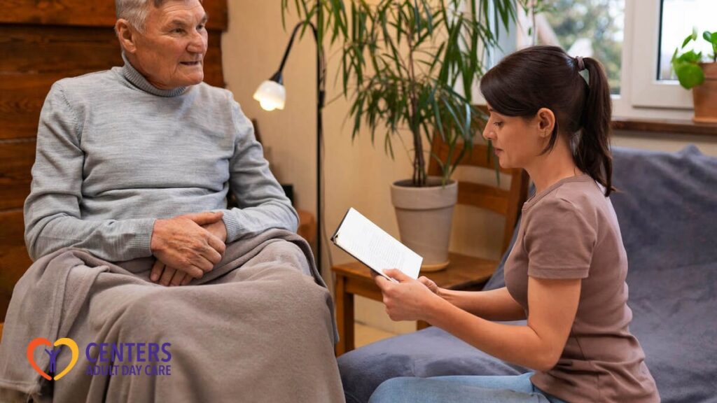 A carer reads to an elderly person.