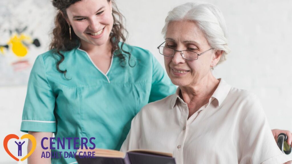 A senior woman reads a book while her caregiver stands nearby, offering guidance and support during the activity at adult day care for your parent.