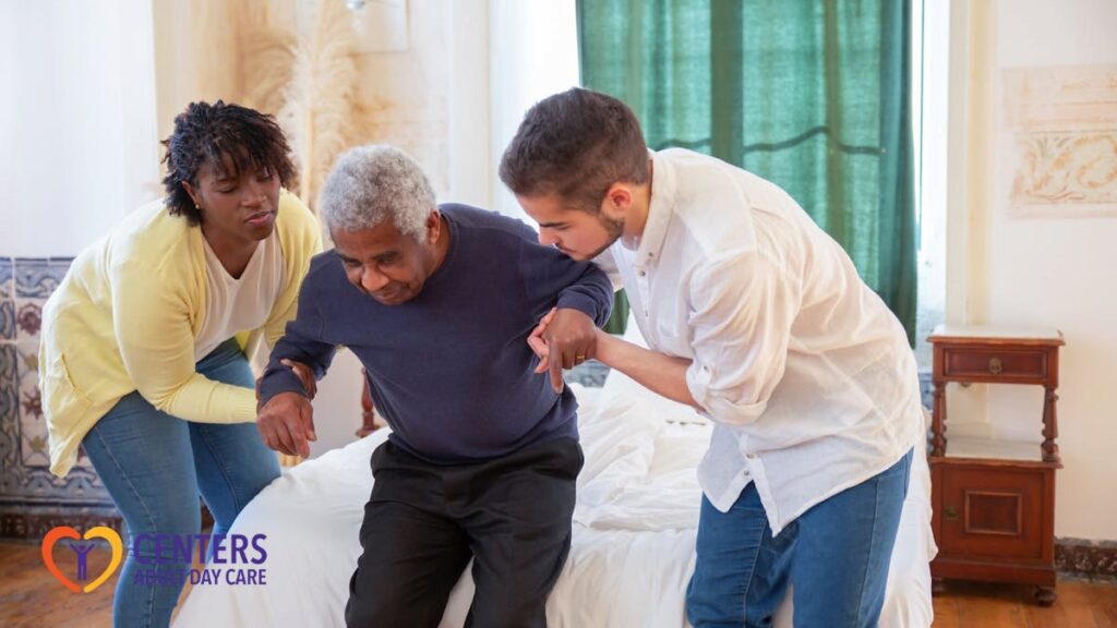A Man and a Woman Assisting an Elderly Man in Standing