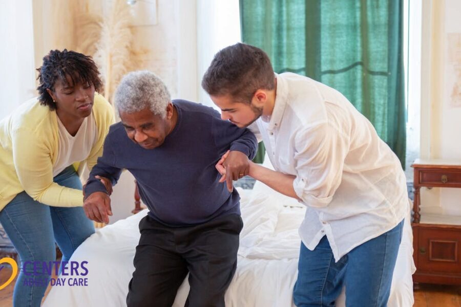 A Man and a Woman Assisting an Elderly Man in Standing
