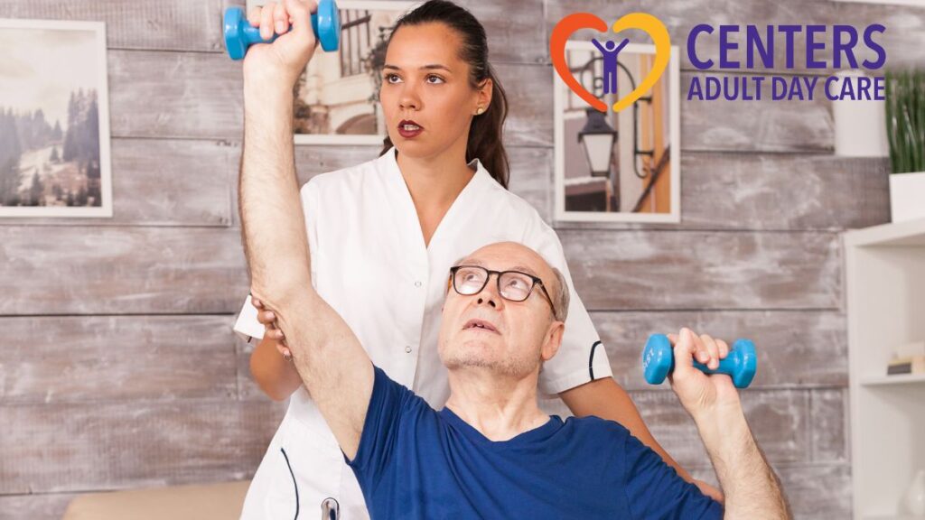 A senior man in a wheelchair lifts handheld weights as his female therapist guides him during physical therapy.