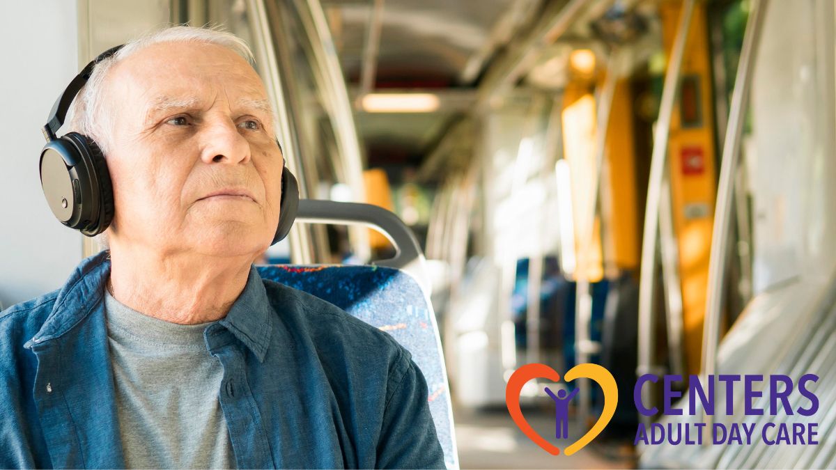 An elderly man rides a train wearing earmuffs, looking serious and thoughtful, highlighting the importance of accessible transportation for seniors.